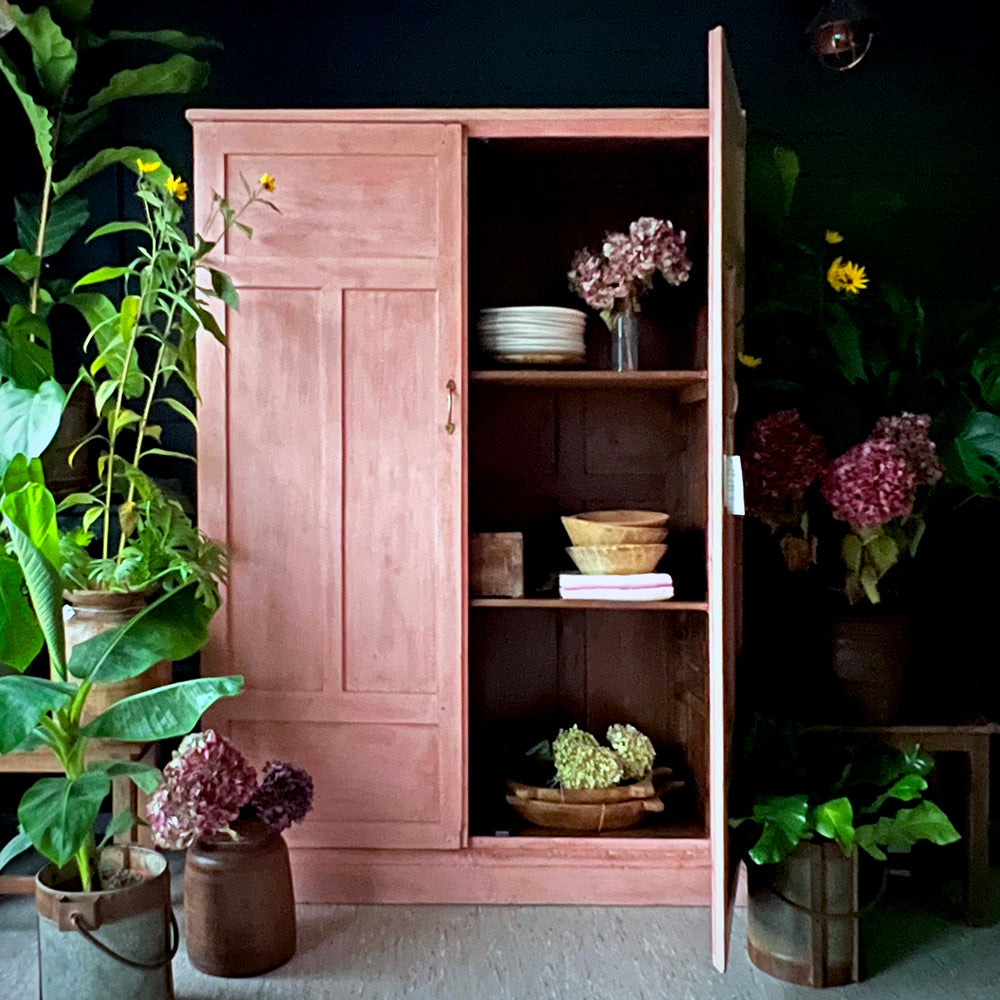 A pink cupboard dresser